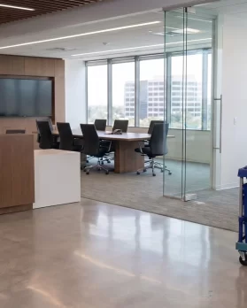 DMS day porter with a cleaning cart in an office lobby